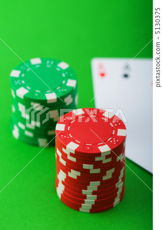 Casino chips and cards against green background 5130375
