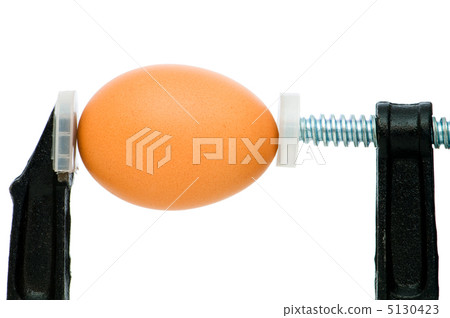 Strength concept with egg and clamp on white Strength concept with egg and clamp on white 5130423