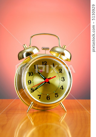 Alarm clock against colourful background 5130929