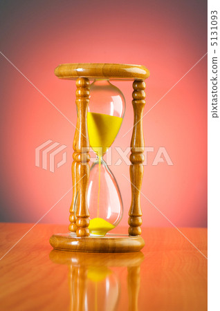 Time concept with hourglass against background 5131093