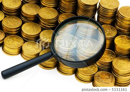Stack of coins and magnifying glass on the white 5131161