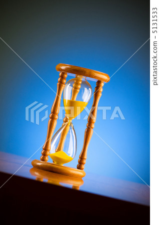 Time concept with hourglass against background 5131533
