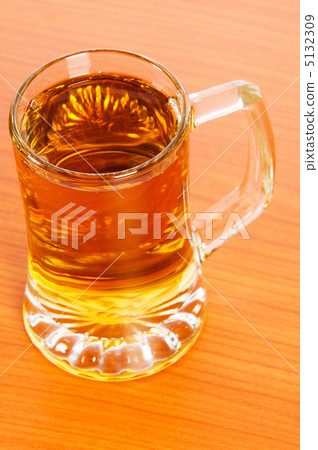 Beer glass on the wooden table Beer glass on the wooden table 5132309
