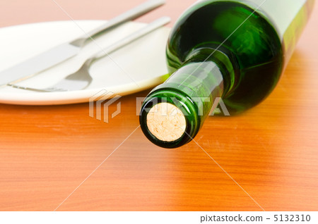 Bottle of wine on the wooden table 5132310