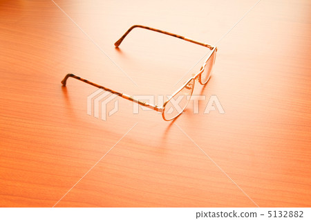 Reading glasses on the wooden table Reading glasses on the wooden table 5132882
