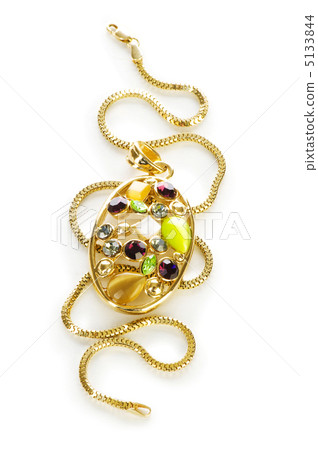 Golden chain and brooch isolated on white Golden chain and brooch isolated on white 5133844