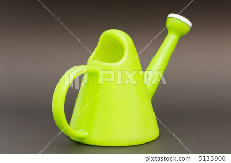 Gardening concept with green watering can on background Gardening concept with green watering can on background 5133900