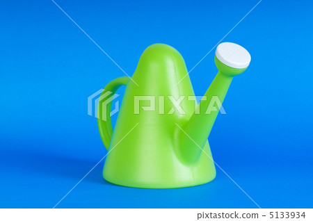 Gardening concept with green watering can on background Gardening concept with green watering can on background 5133934