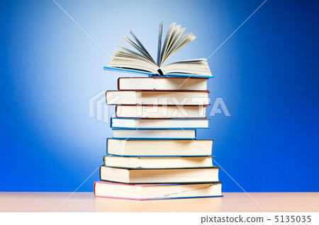 Stack of text books against gradient background Stack of text books against gradient background 5135035