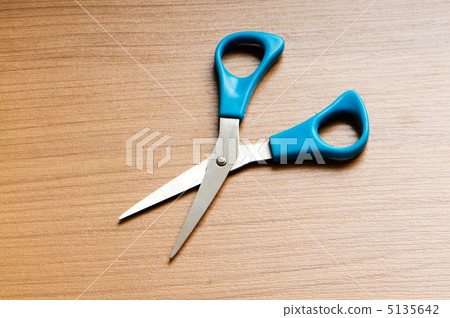 Various scissors on the wooden background 5135642