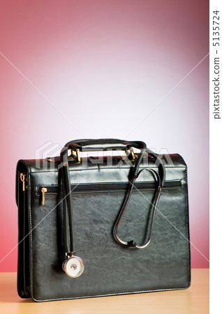 Doctor's case with stethoscope against colorful background 5135724