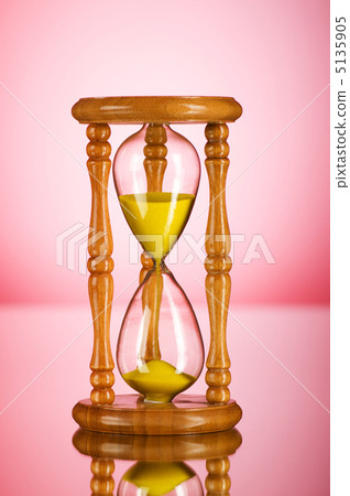 Time concept - hourglass against the gradient background Time concept - hourglass against the gradient background 5135905
