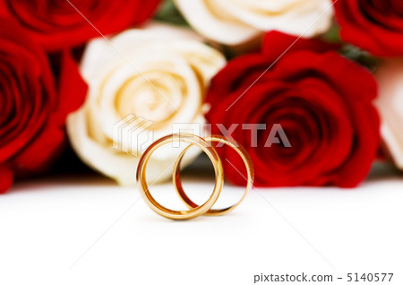 Roses and wedding rings isolated on the white Roses and wedding rings isolated on the white 5140577