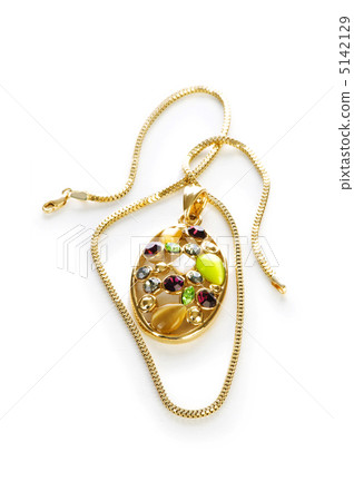 Golden chain and brooch isolated on white 5142129