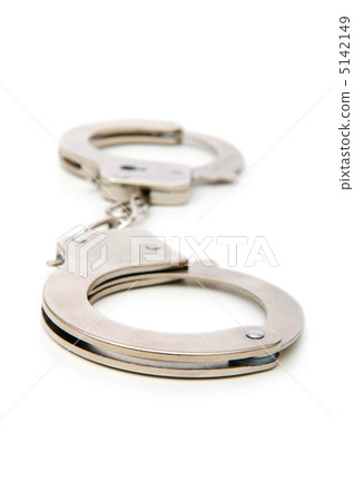 Metal handcuffs isolated on the white background Metal handcuffs isolated on the white background 5142149
