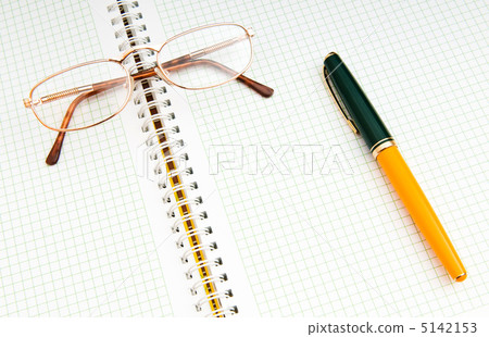 Pen and eye glasses on the page Pen and eye glasses on the page 5142153