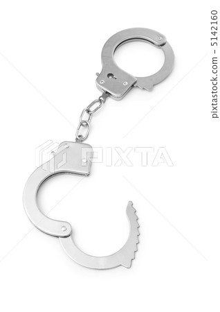 Metal handcuffs isolated on the white background Metal handcuffs isolated on the white background 5142160