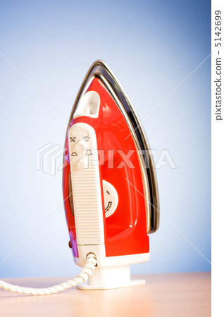 Modern electric iron against the colorful background 5142699