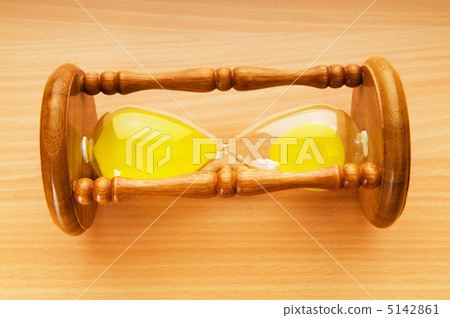 Time concept - hourglass against the wooden background 5142861