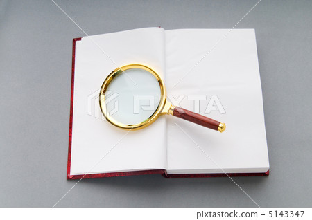 Magnifying glass over the stack of books Magnifying glass over the stack of books 5143347