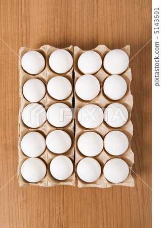 Many white eggs on the wooden table 5143691