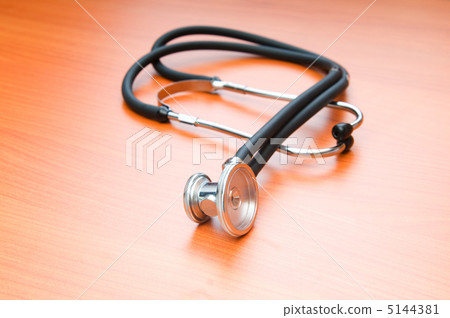 Medical concept - stethoscope on the wooden table Medical concept - stethoscope on the wooden table 5144381