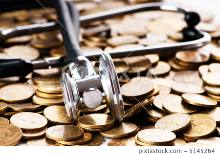 Concept of expensive healthcare with coins and stethoscope Concept of expensive healthcare with coins and stethoscope 5145264