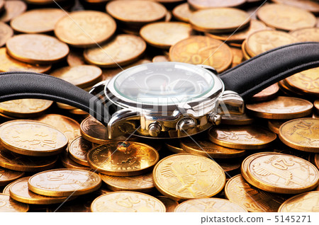 Time is money concept with watch and coins. Time is money concept with watch and coins. 5145271