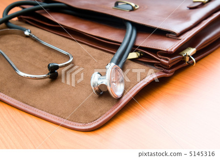 Doctor's case with stethoscope against wooden background 5145316