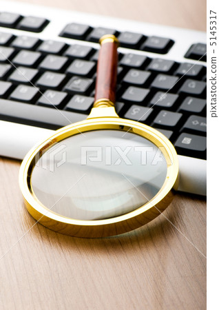 Computer security concept with keyboard and magnifying glass 5145317