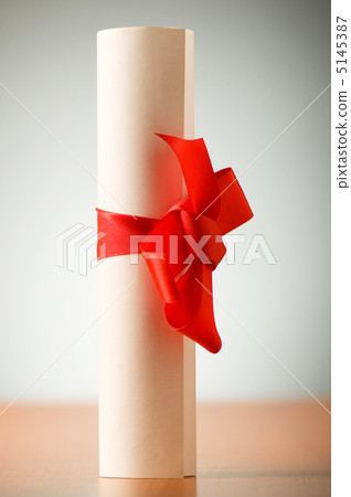 Education concept - diploma roll on the wooden table 5145387