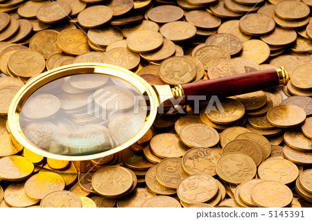 Magnifying glass and coins at the background Magnifying glass and coins at the background 5145391
