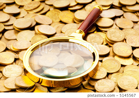 Magnifying glass and coins at the background 5145567