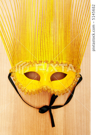 Ornate masks isolated on the wooden background 5145682