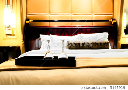 Two glasses on the double bed as romantic concept Two glasses on the double bed as romantic concept 5145919
