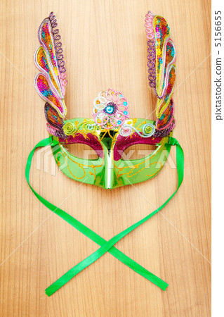 Ornate masks isolated on the wooden background Ornate masks isolated on the wooden background 5156655