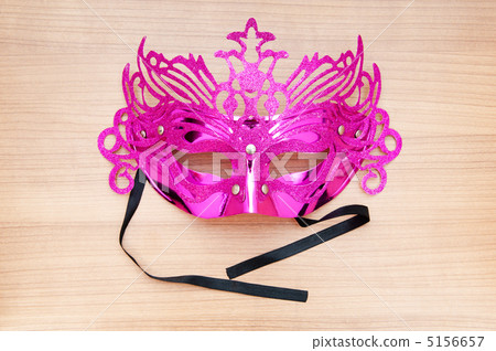 Ornate masks isolated on the wooden background Ornate masks isolated on the wooden background 5156657