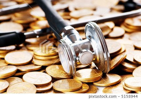 Concept of expensive healthcare with coins and stethoscope 5158944