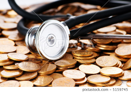 Concept of expensive healthcare with coins and stethoscope 5159745