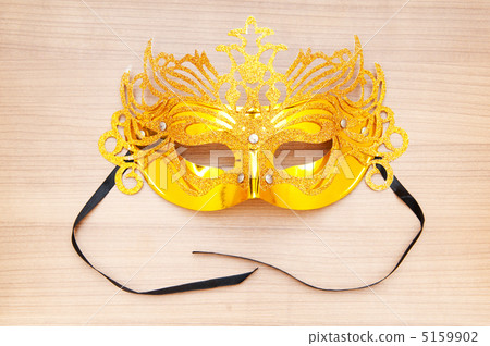 Ornate masks isolated on the wooden background Ornate masks isolated on the wooden background 5159902