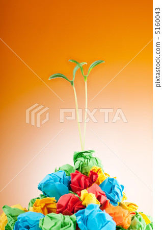 Paper recycling concept with seedlings on white 5160043