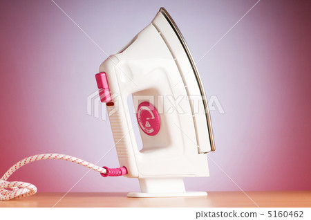 Modern electric iron against the colorful background Modern electric iron against the colorful background 5160462