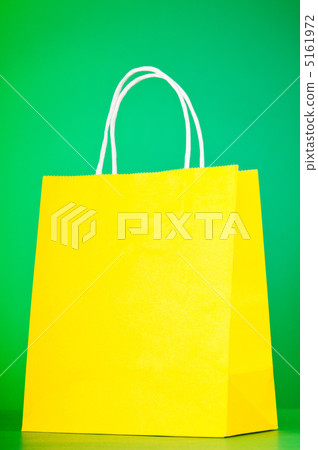 Colourful paper shopping bags against gradient background 5161972