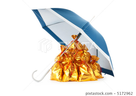 Golden sacks under protection of umbrella 5172962