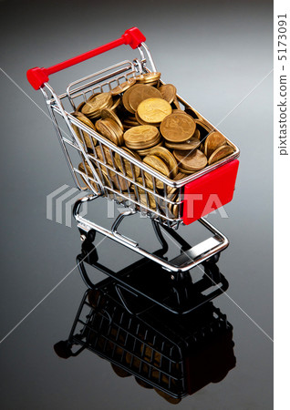 Gold coins in shopping cart 5173091