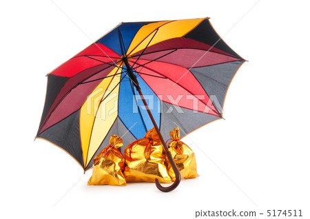 Golden sacks under protection of umbrella 5174511