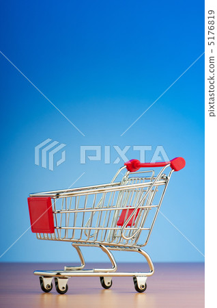 Mini shopping cart against gradient background Mini shopping cart against gradient background 5176819