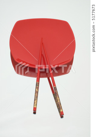 Red plate and chopsticks on reflective background 5177673