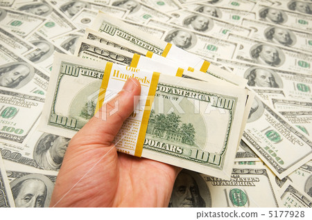 Hand holding american dollars against money background Hand holding american dollars against money background 5177928