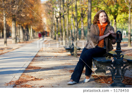 Beautiful girl sitting at the bench in Paris by fall Beautiful girl sitting at the bench in Paris by fall 5178450